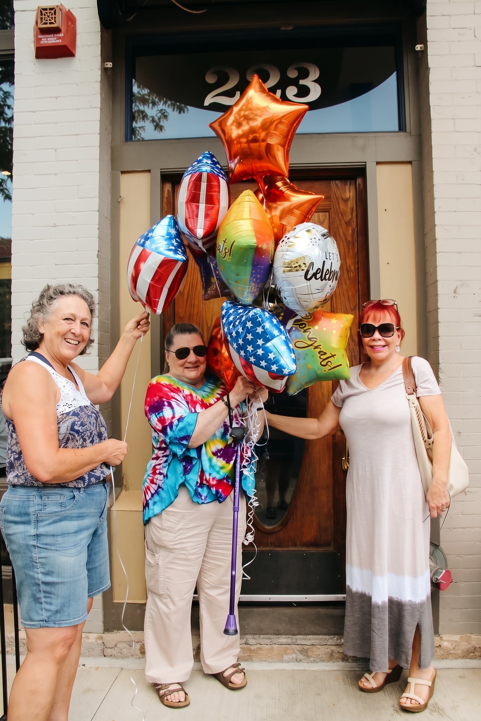 Guests celebrating with star and balloon bouquets outside the Old Town parlor