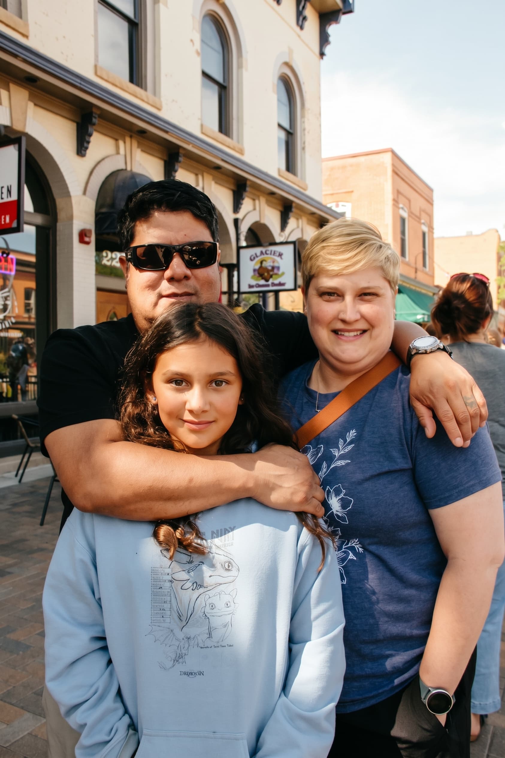 A family hug on the patio during opening day