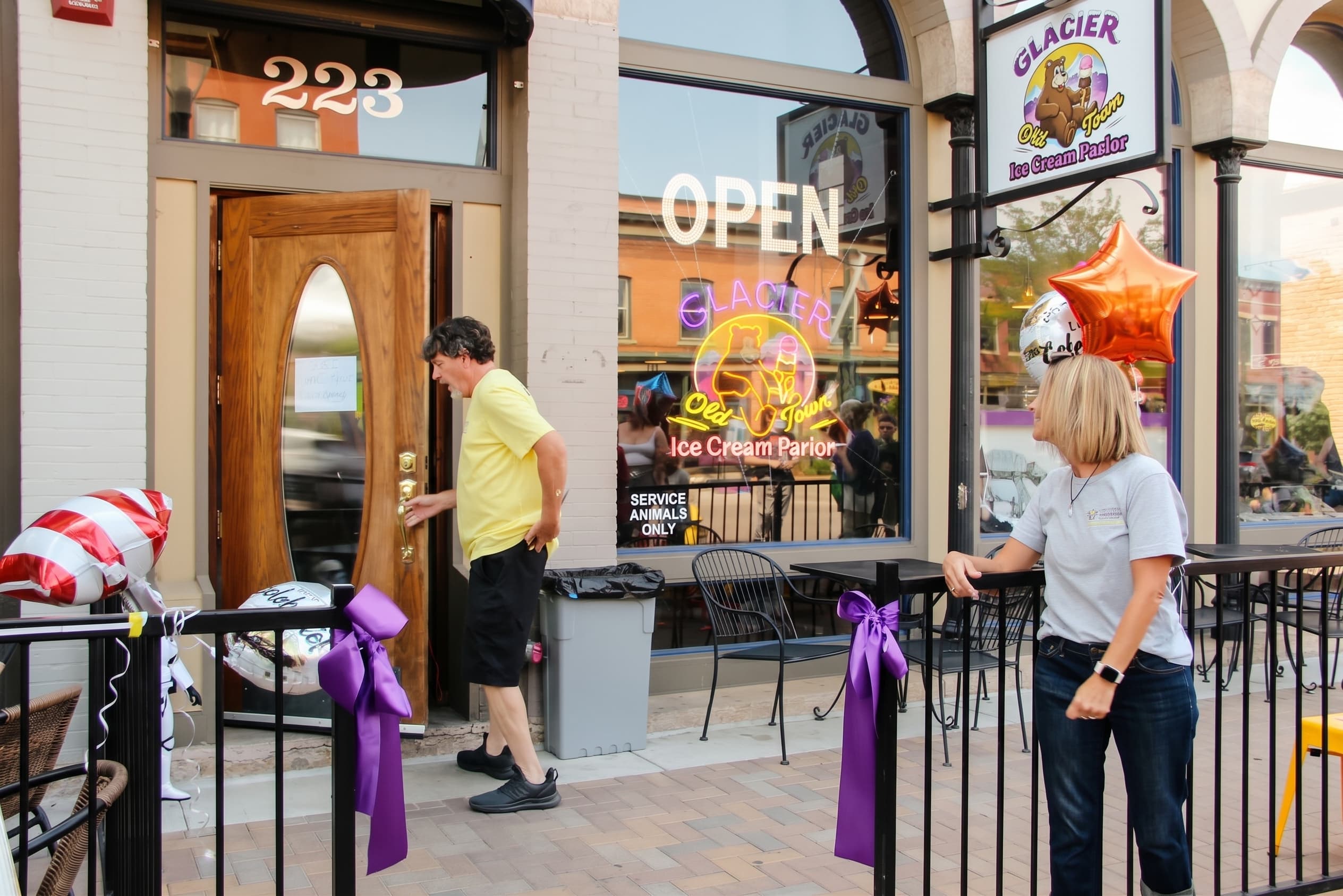The open front door wrapped in purple ribbon on opening day