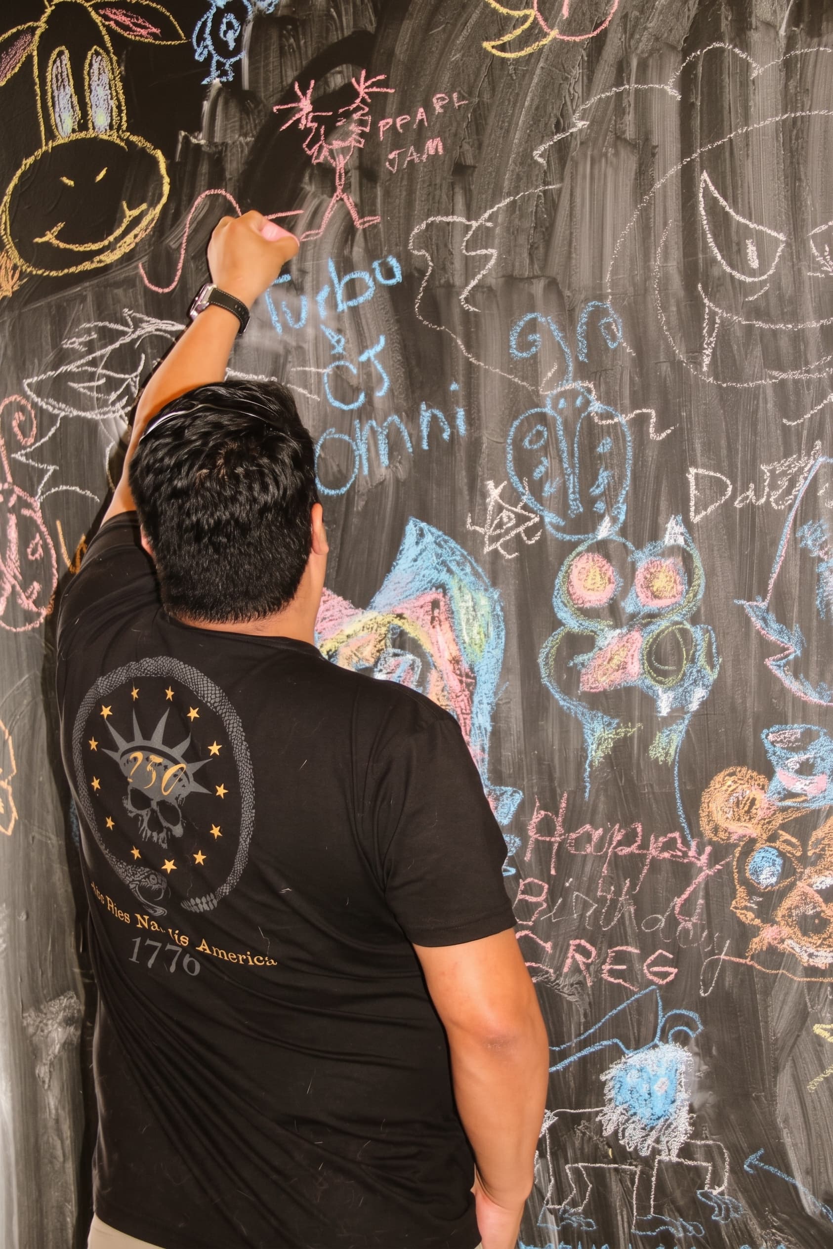 Guests drawing on the chalkboard doodle wall
