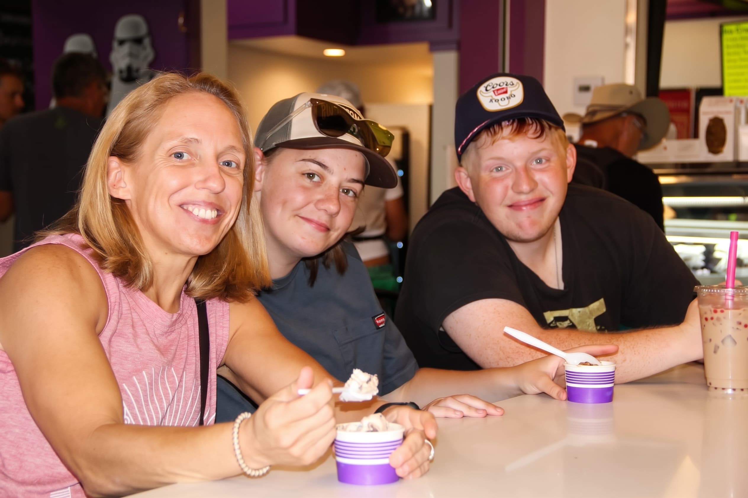 A family enjoying sundaes and shakes at the counter