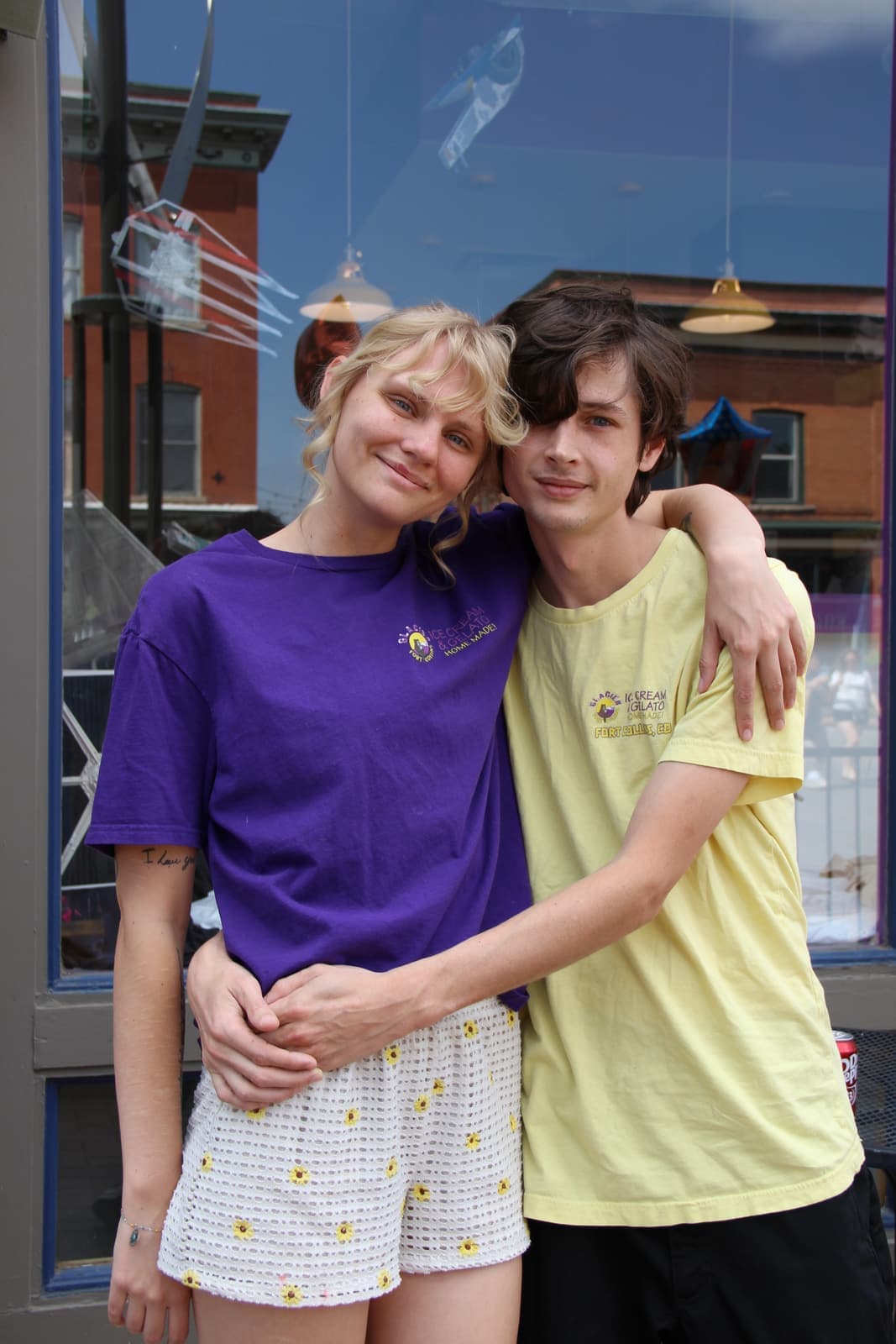 Two friends in Glacier crew shirts outside the parlor windows
