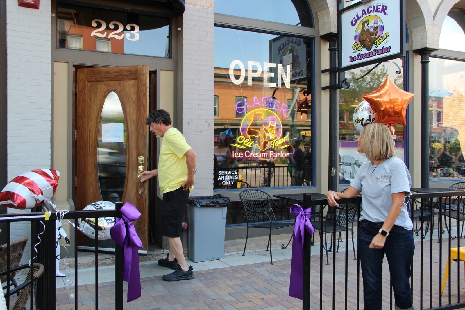 The open front door wrapped in purple ribbon on opening day
