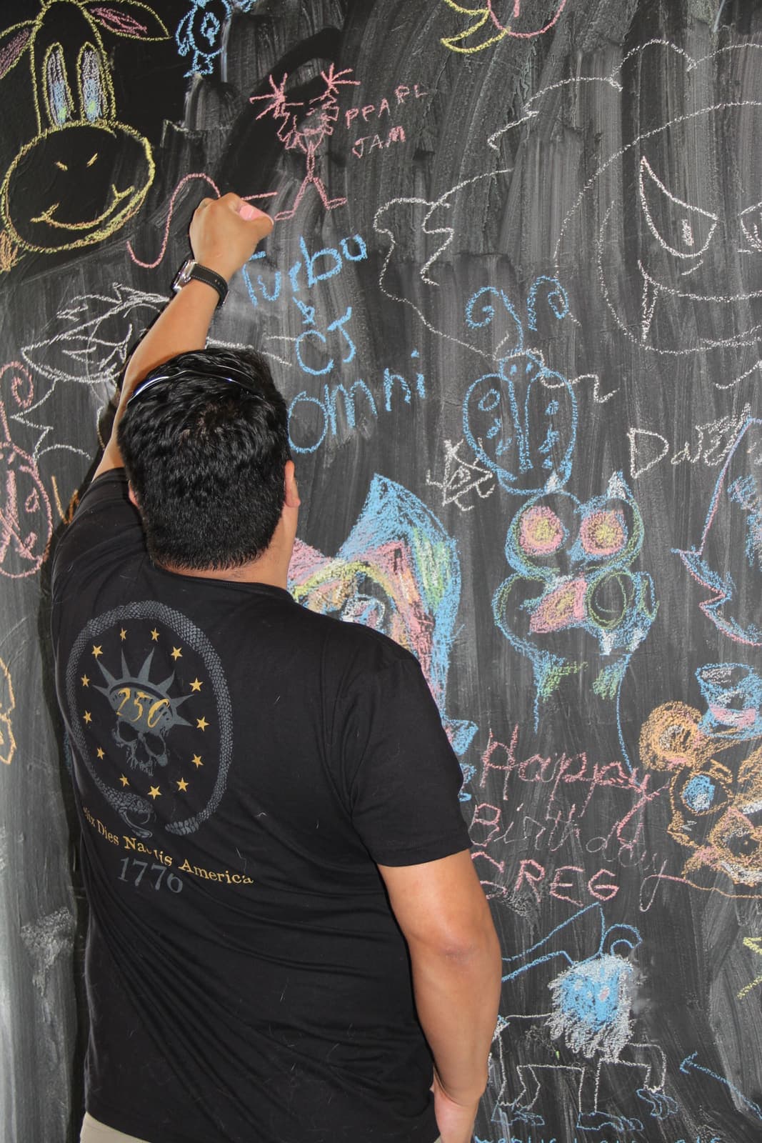 Guests drawing on the chalkboard doodle wall