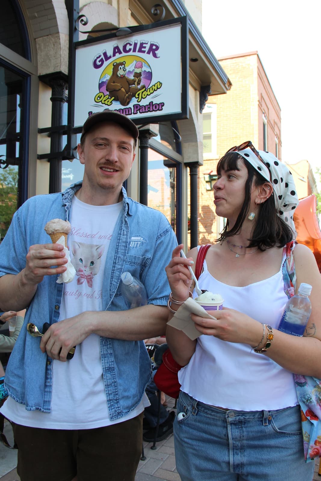 A couple with cones under the Glacier sign on Linden Street