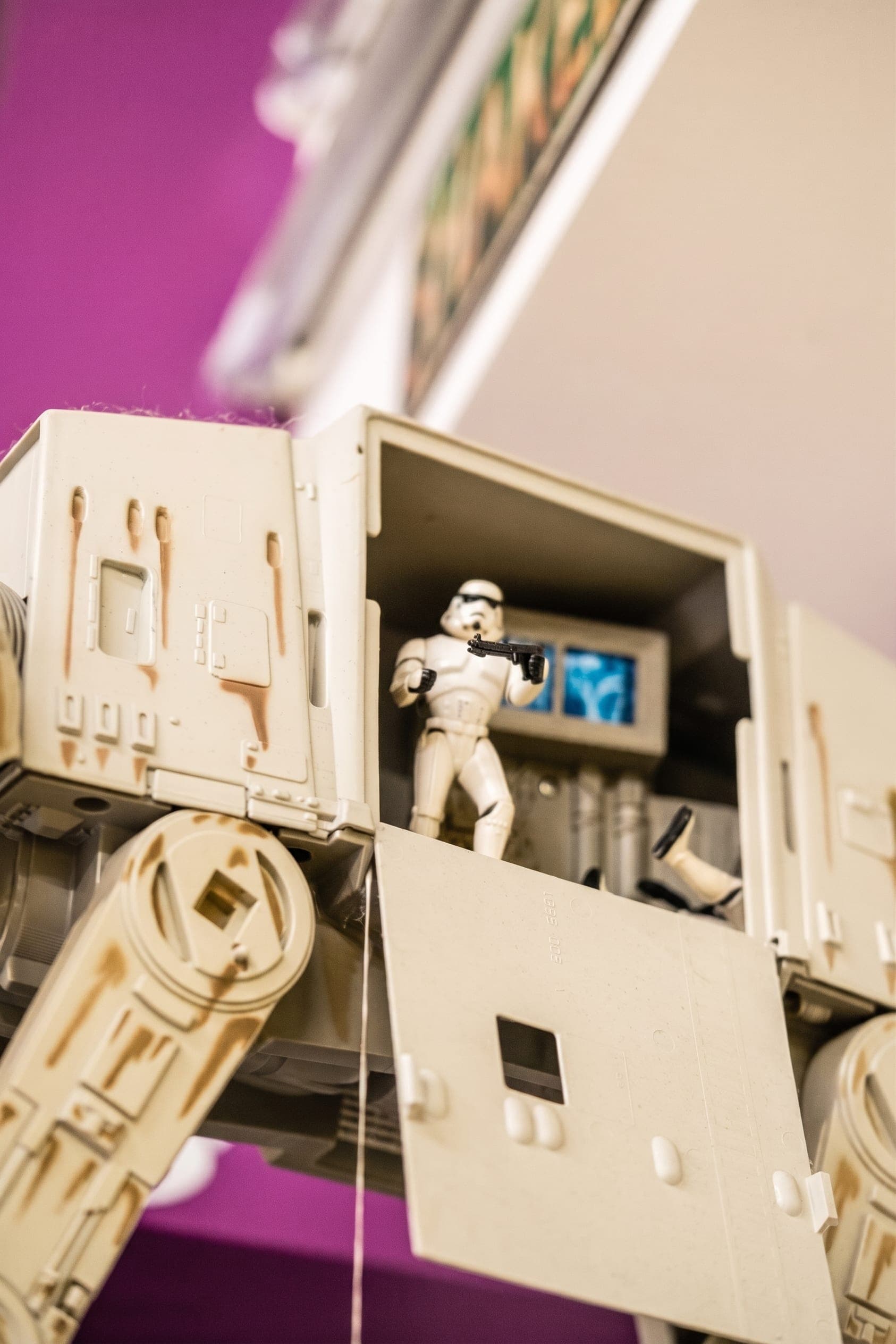 Star Wars AT-AT walker toy with a stormtrooper figure against the parlor's purple wall
