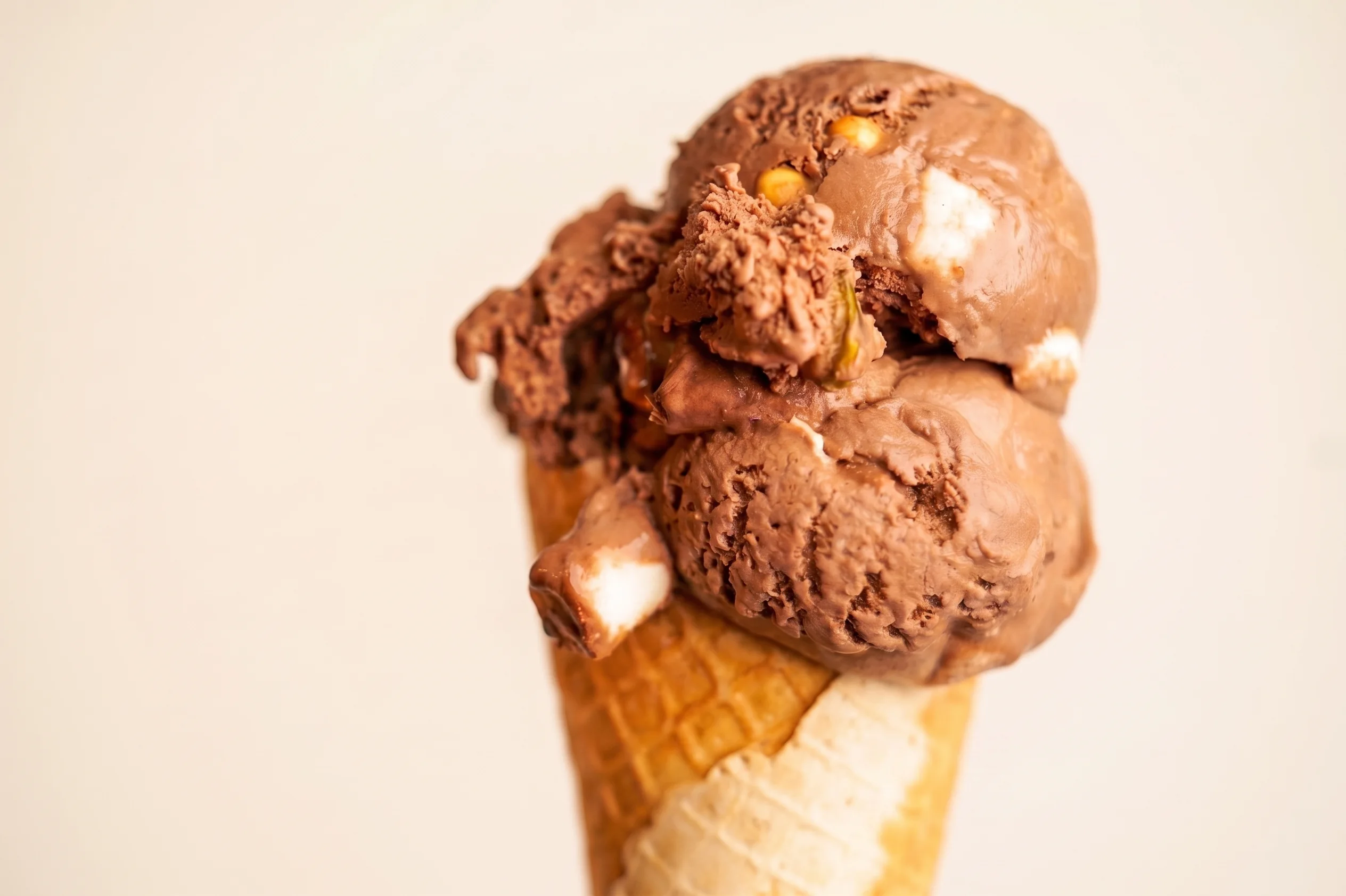 Chocolate ice cream scoop with mix-ins on a waffle cone at Glacier