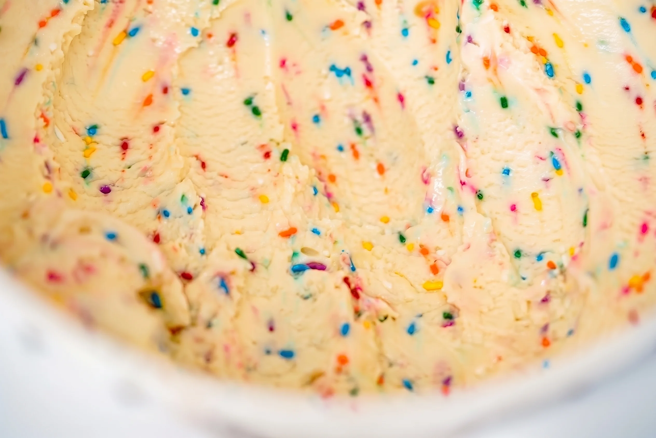 Rainbow sprinkle ice cream in a fresh tub at Glacier